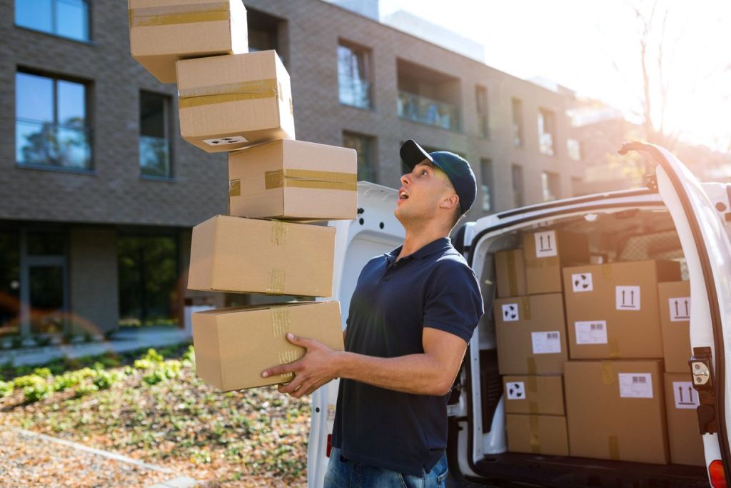 A delivery man dropping boxes.